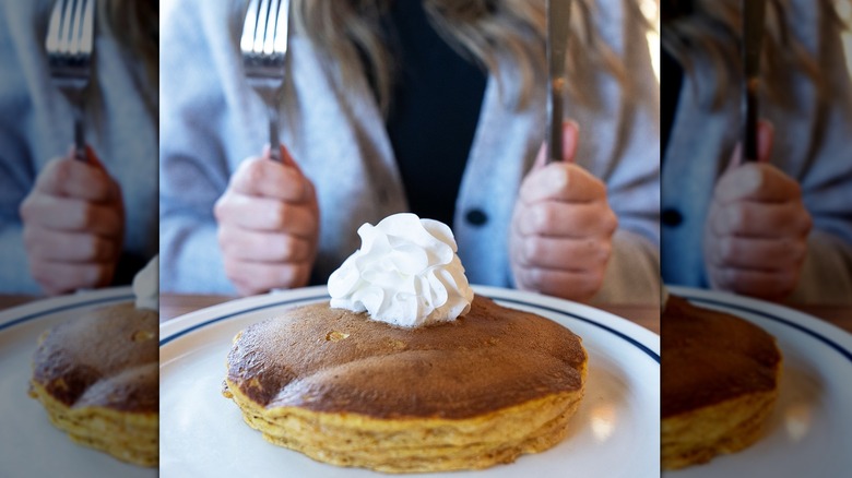 pancakes whipped cream knife fork