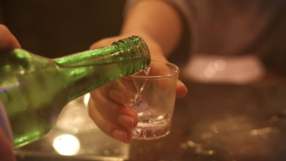 Pouring soju into glass