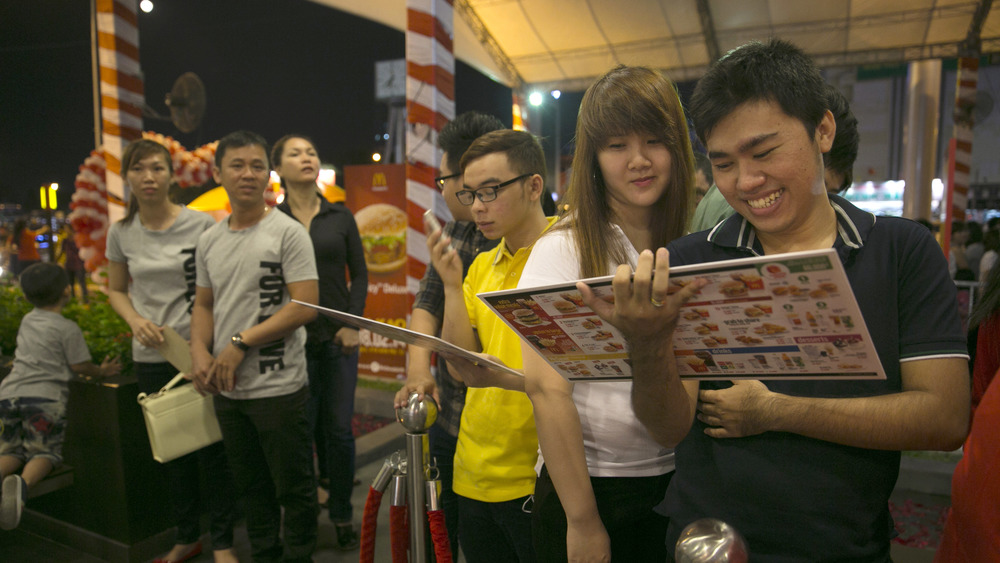 People looking at Vietnamese restaurant menu