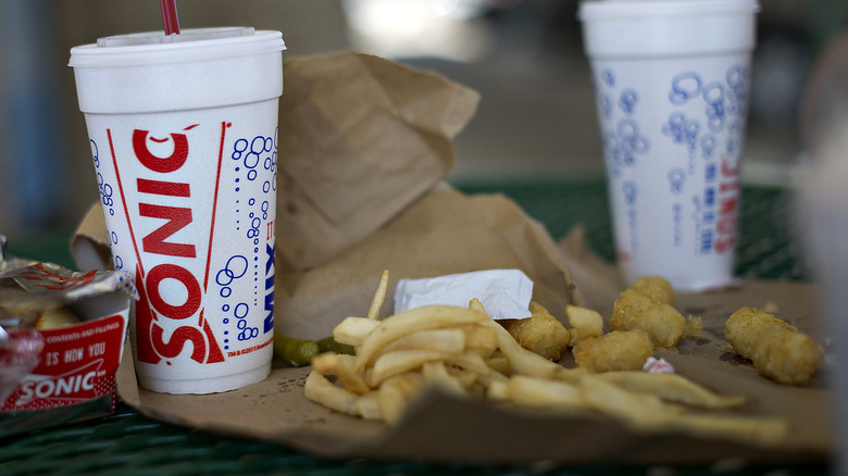 fries and tots on a table outside Sonic