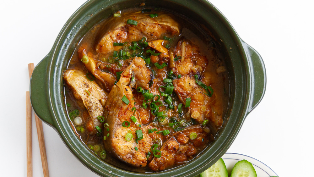 clay pot catfish in a green bowl