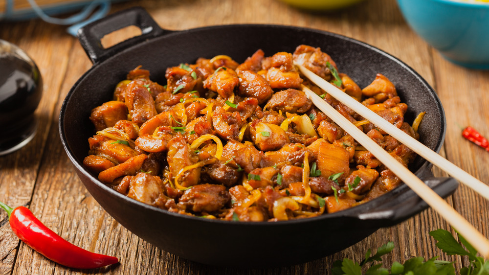 Cast iron pan with caramelized chicken