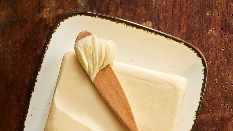 butter with wooden spreader