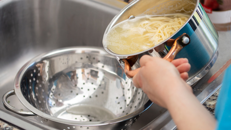 straining pasta in sink