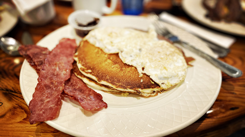 Turkey bacon on plate with pancakes and eggs