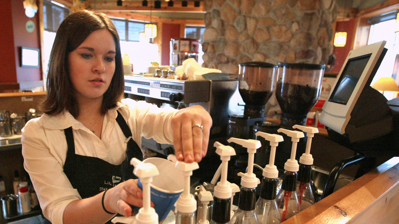 Caribou Coffee barista filling order