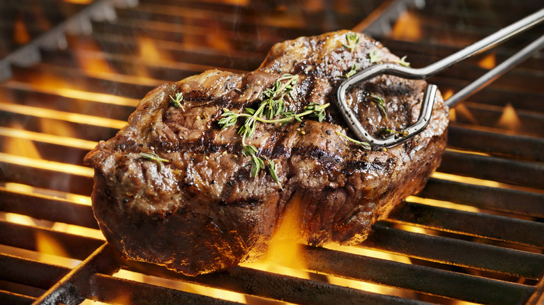 Steak over flaming grill