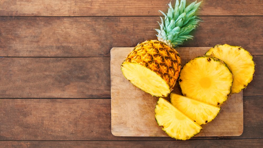 Cut pineapples on a wooden board