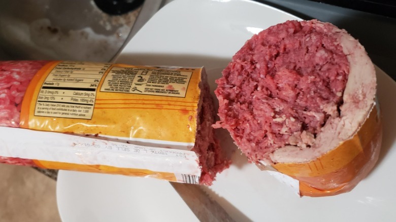 Tube of Aldi ground beef surrounded by fat