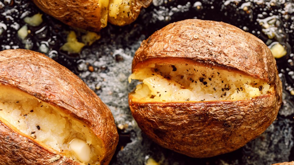 Crispy jacket potatoes with salt, black pepper, and butter