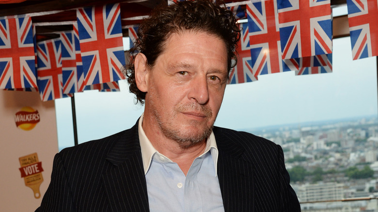 Marco Pierre-White with messy hair and jacket