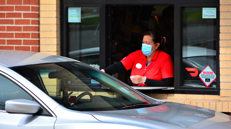 Chick-fil-A staff member in mask at drive-thru