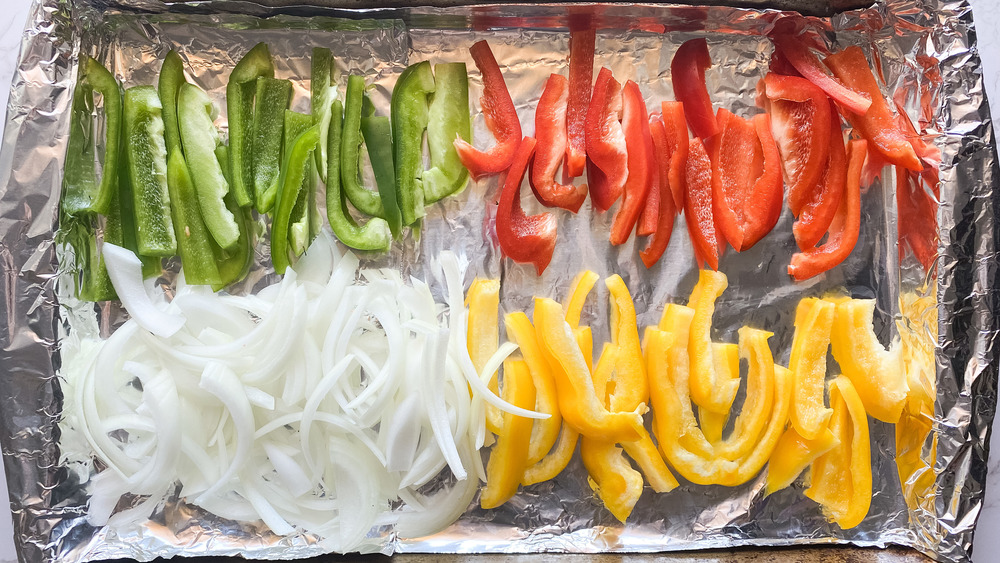 sliced green red and yellow bell pepper with onions for fajitas