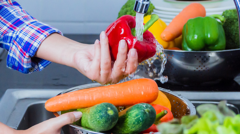 A variety of vegetables being washed