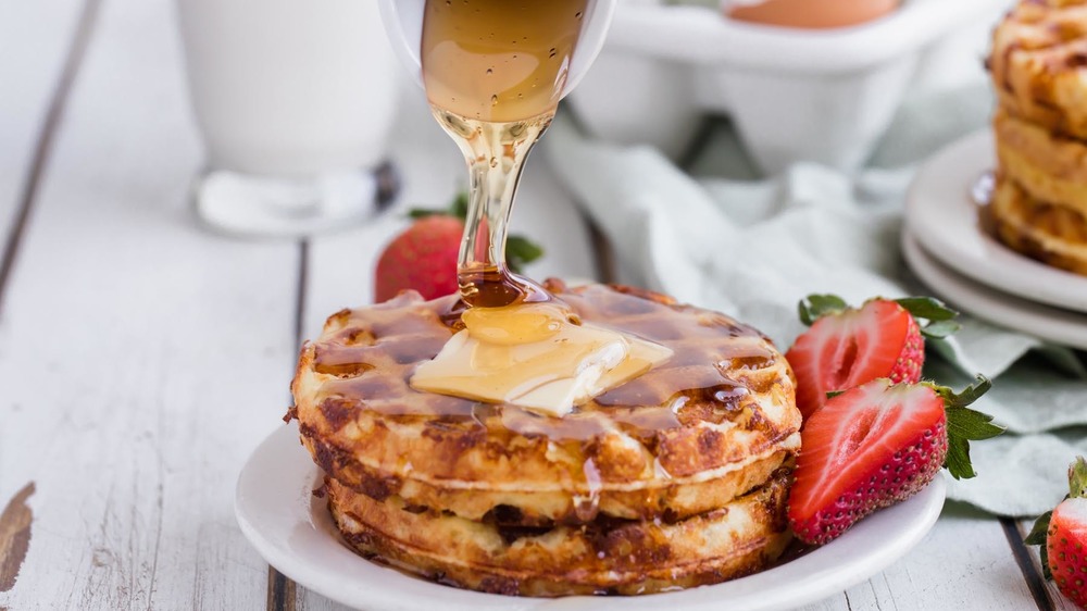 Syrup drizzling over stack of chaffles for chaffle recipe