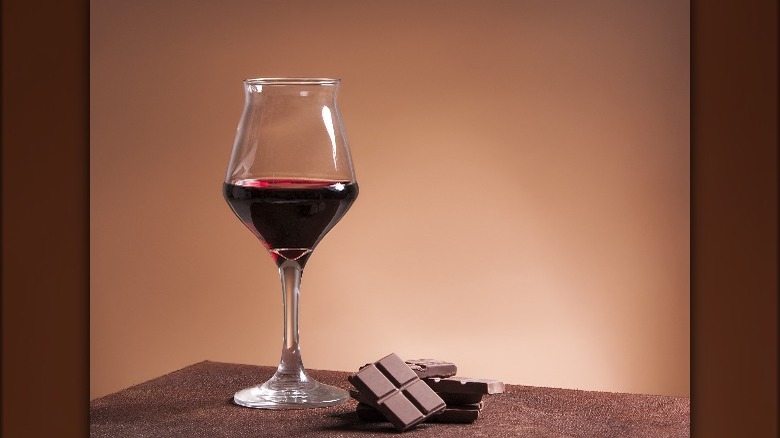 A glass of wine accompanied by chocolate