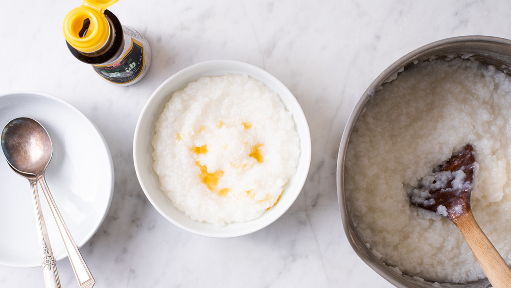 White bowls with congee and sesame oil