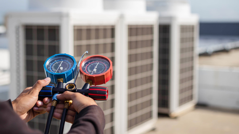 Person testing air conditioner levels