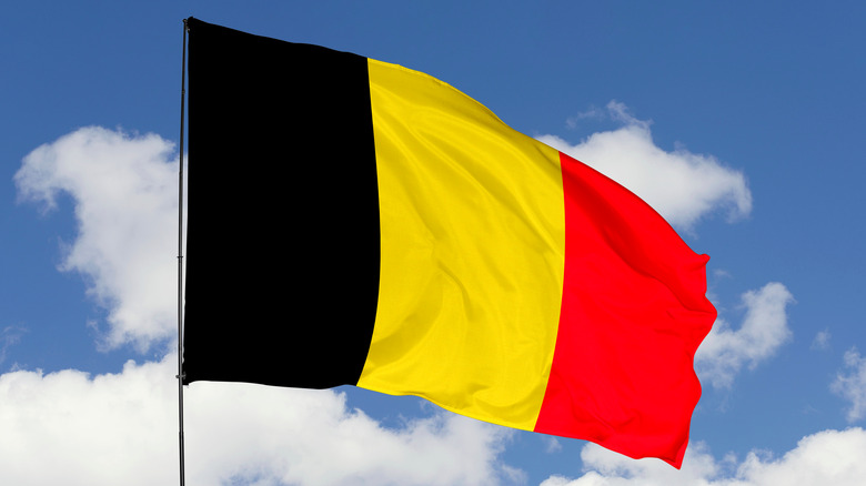 Belgian flag against blue sky