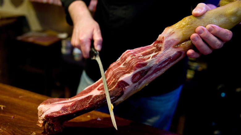 Butcher slicing Iberian bellota ham