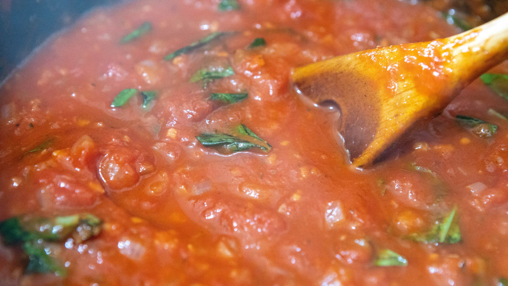 pizza sauce simmering for deep dish pizza recipe