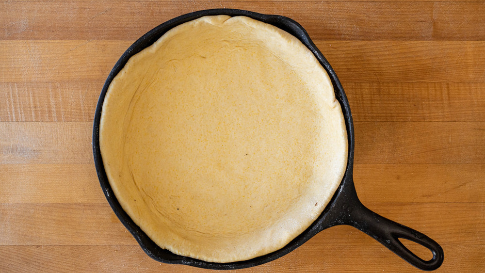 pizza dough in pan for deep dish pizza recipe