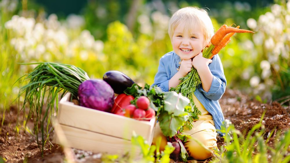 Child holding carrots