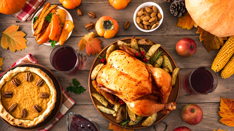 Thanksgiving table with turkey and pumpkin pie