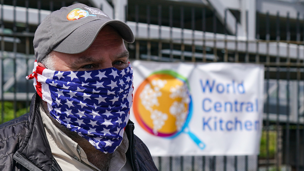 Jose Andres before a World Central Kitchen banner