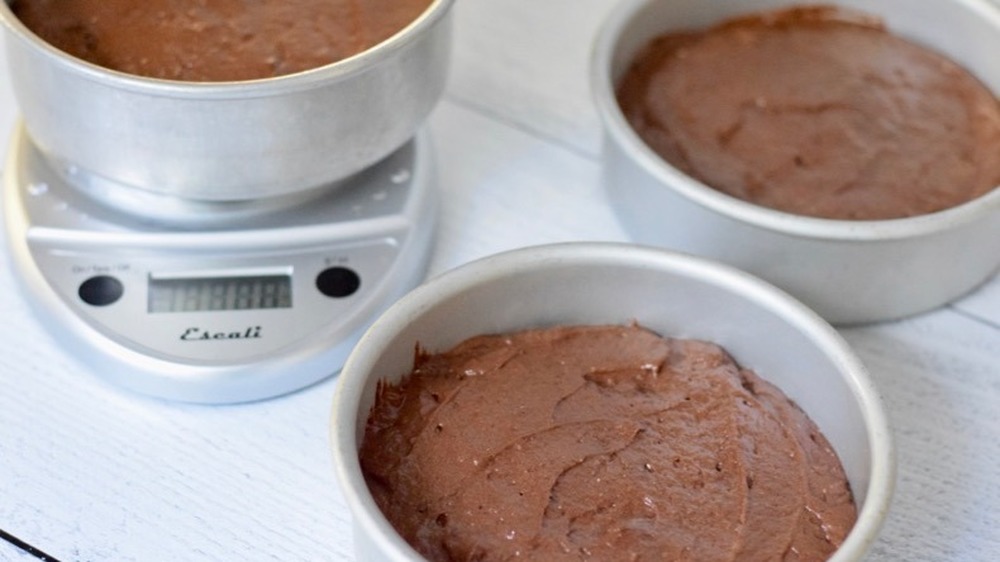 German chocolate cake batter in prepared cake pans