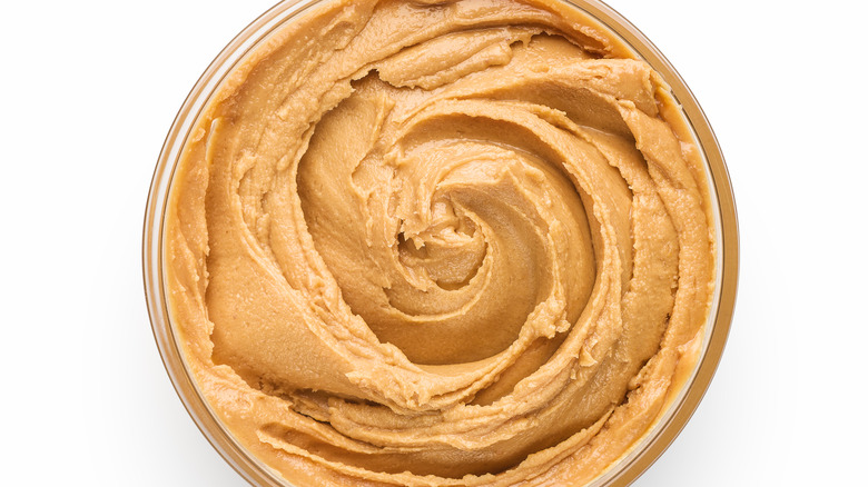 Bowl of peanut butter on a white backdrop