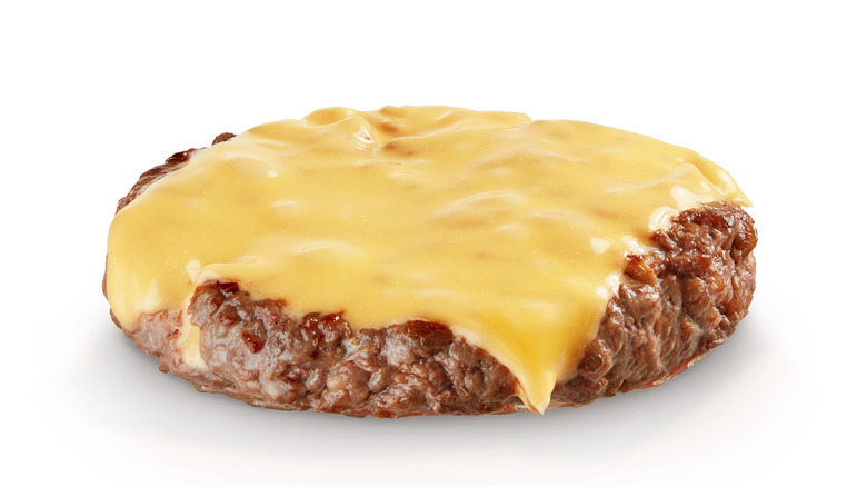 Cheese melting on a hamburger