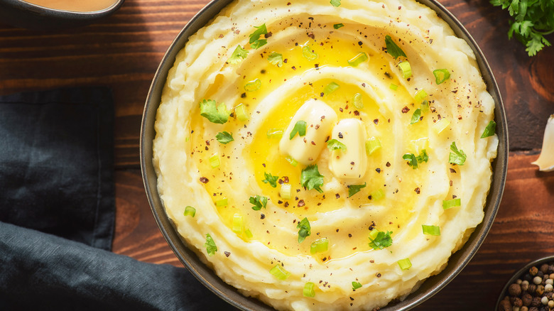 mashed potatoes with butter and greens on top