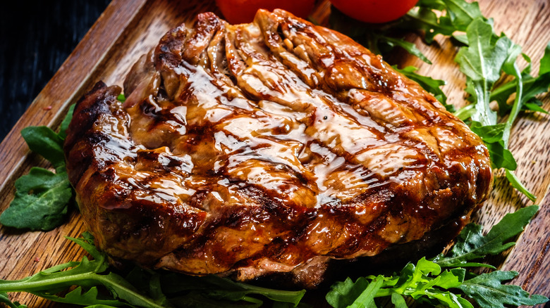 Grilled fillet steak served on wooden board