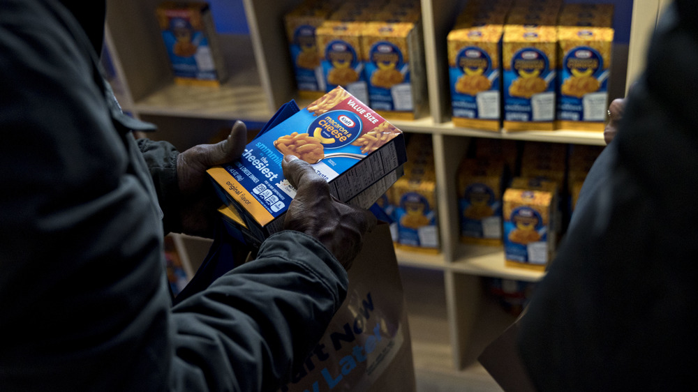 person holding Kraft Macaroni & Cheese