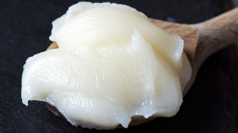 Lard piled in a wooden spoon