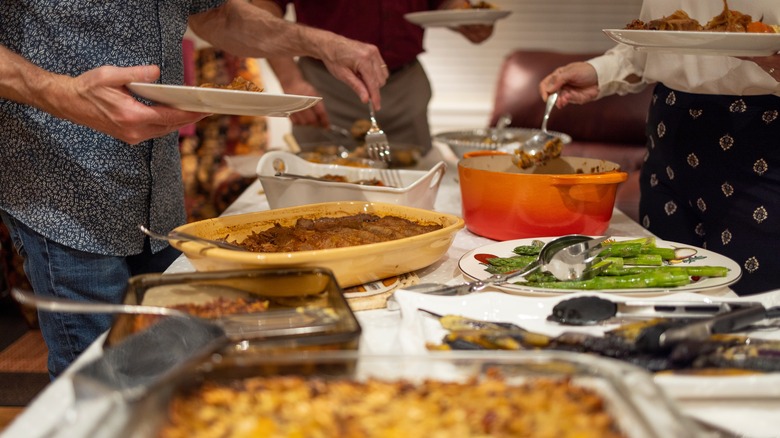 people getting food at potluck 