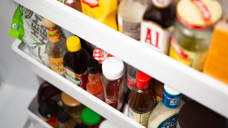 rows of condiments in fridge