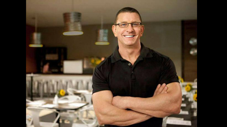 Robert Irvine posing in restaurant