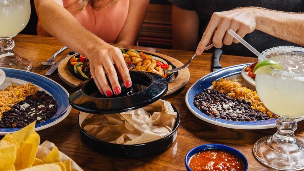 A table full of mexican food at On The Border restaurant