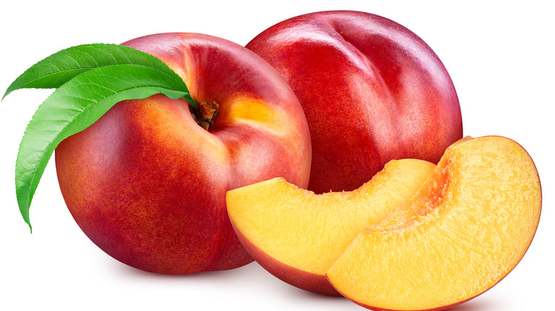 Two nectarines with two slices