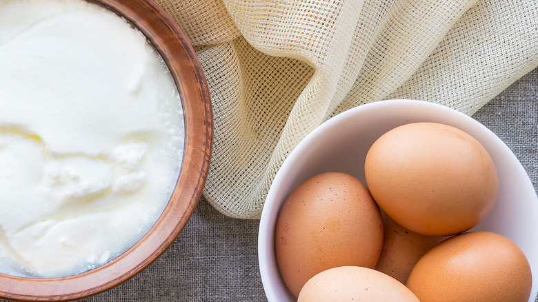 Sour cream and eggs in bowls