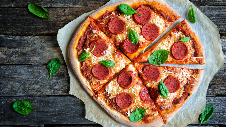 vegan pepperoni pizza on a dark wood background