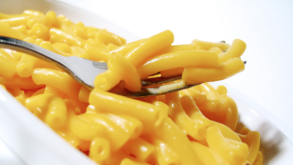 A forkful of mac and cheese in a bowl