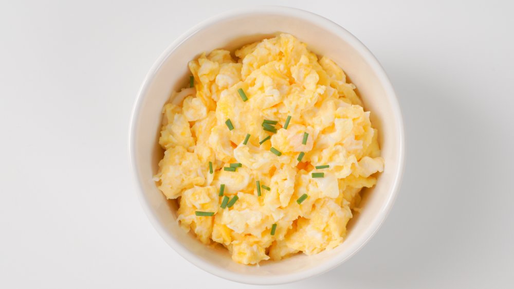 Bowl of scrambled eggs with chives