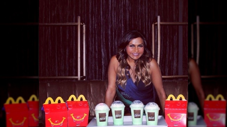 Mindy Kaling with McDonald's Happy Meals and shakes