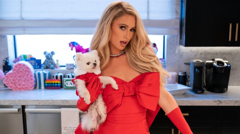 Paris Hilton holding dog in kitchen