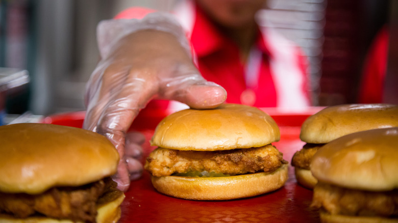 Chick-Fil-A employee handling a chicken sandwich