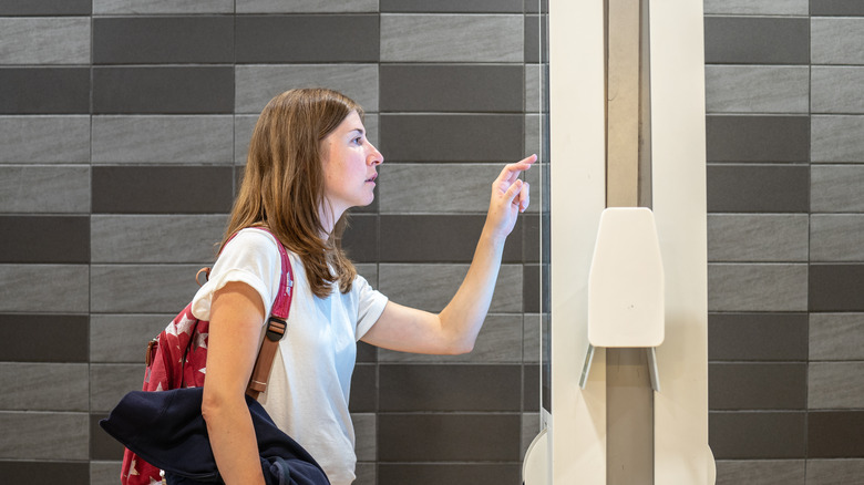 Caucasian woman ordering at McDonald's kiosk