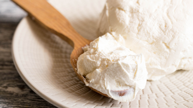 Mascarpone cheese on wooden spoon